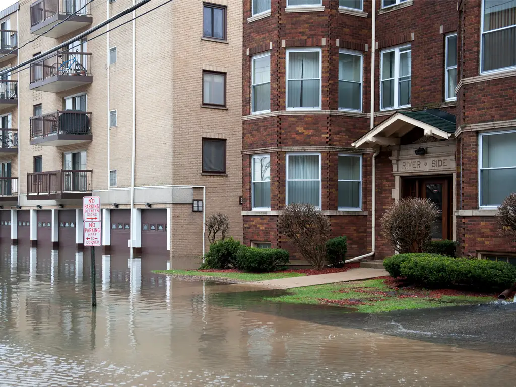 Water flooding into apartment buildings.