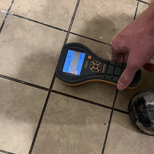 Moisture meter detecting presence of potential water damage.