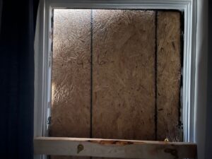 Boarded up window from fire damage